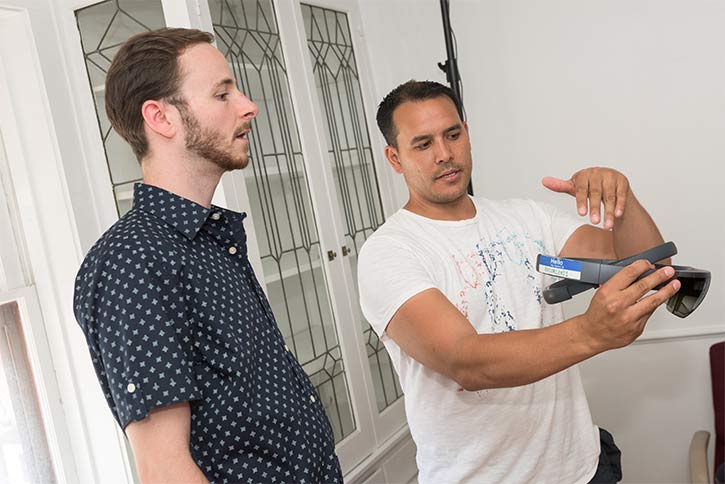 <span class="content-image-text">Reynaldo Zabala explaining the wireless VR headset at WMCF</span>