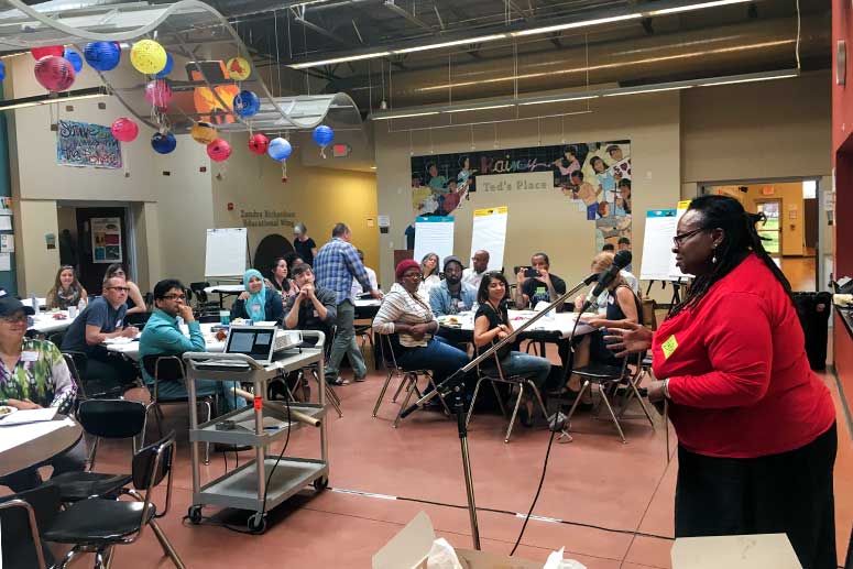 <span class="content-image-text">Gwen Garth, an artist and CAC board member, and a member of the SfAPT speaking at a meeting</span>