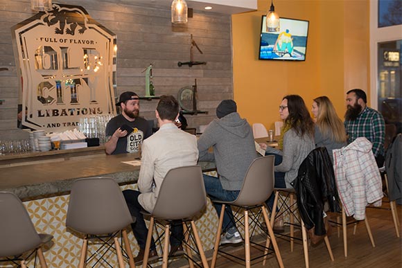 <span class="content-image-text">General Manager Rob Dorsey talking with patrons at Old City Libations</span>