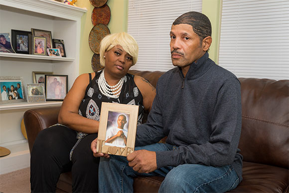 Deborah Wade and Darrick Wade with a photo of their son Demetrius