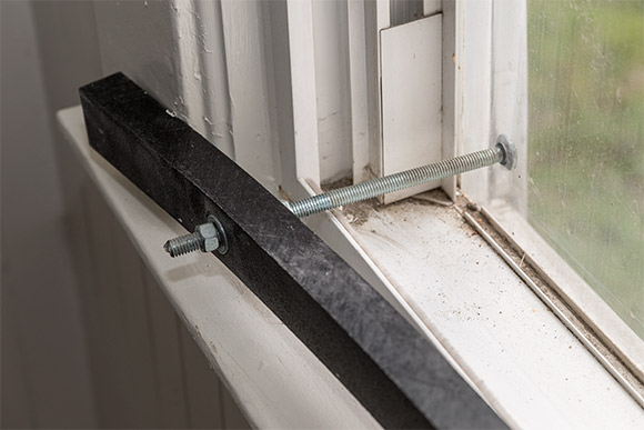 Window systems are installed utilizing interior clamping beams composed of high density polyethylene and secured using corrosion resistant carriage bolts and/or security head screws