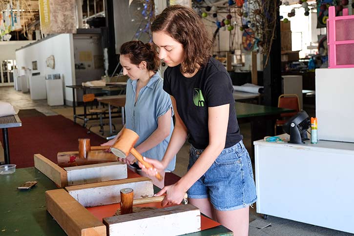 Summer interns Malena Grigloli and Catherine Carroll process kozo