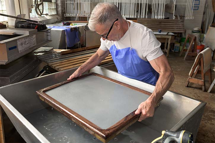 Pulling sheets of abaca paper