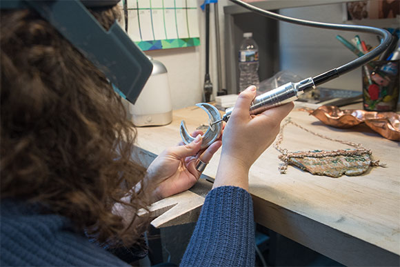 <span class="content-image-text">David at work on a new design at her CIA workspace</span>