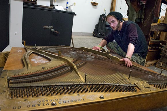 <span class="content-image-text">Byham eyes his next project that includes a piece of a salvaged piano</span>