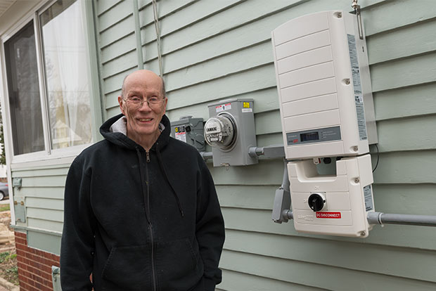 <span class="content-image-text">Paul Schroeder and the solar DC-AC inverter on the side of his home in Old Brooklyn</span>