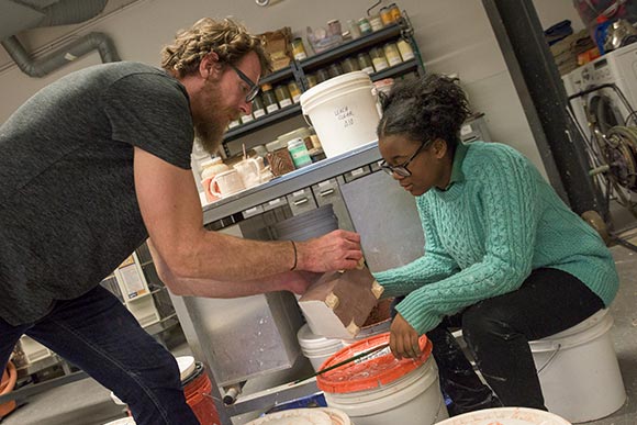 <span class="content-image-text">Ceramic instructor Billy Ritter working with a student</span>