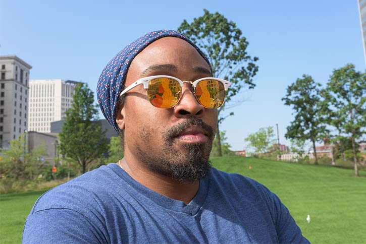 artist Olalekan "LEk" Jeyifous watches the installation of Protest in Public Square