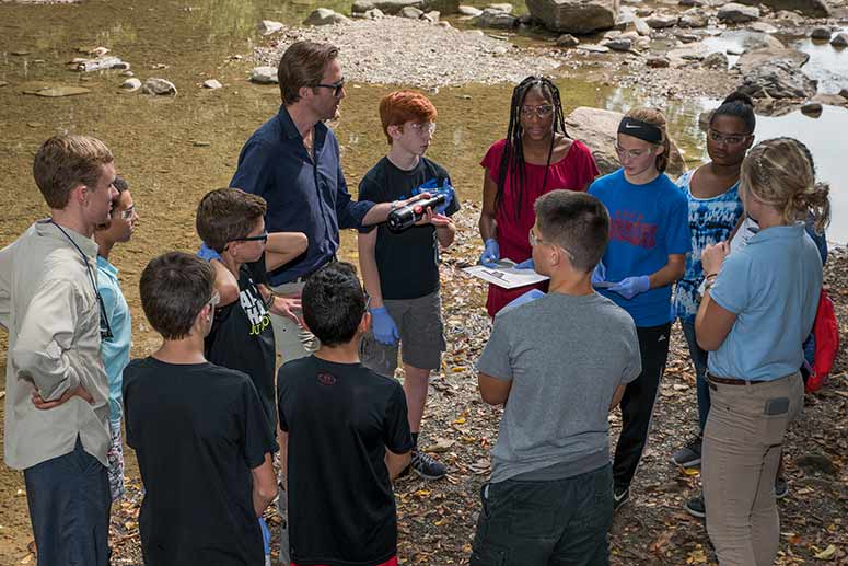 Cousteau with students water testing at the Everett Covered Bridge