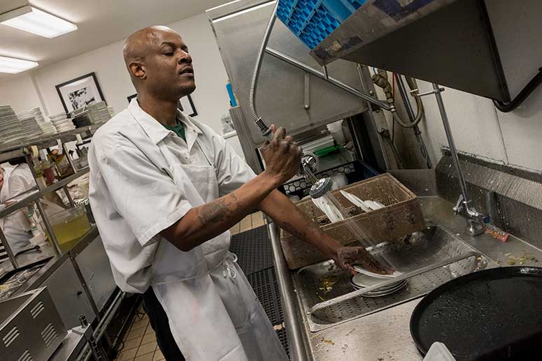 Dishwasher at Edwins Charles Gill who is legally blind