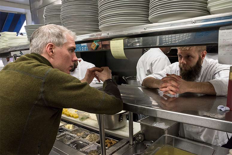 <span class="content-image-text">Brandon Chrostowski discussing menu items with Chef Kyle Fioretti</span>