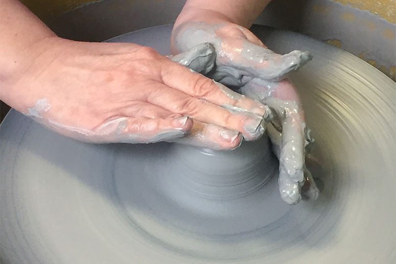 Kat Tarrant throwing a piece on the wheel.