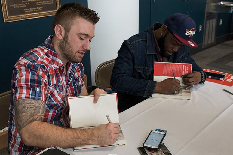 Andrew Collins and Jameel McGee signing their book: Convicted