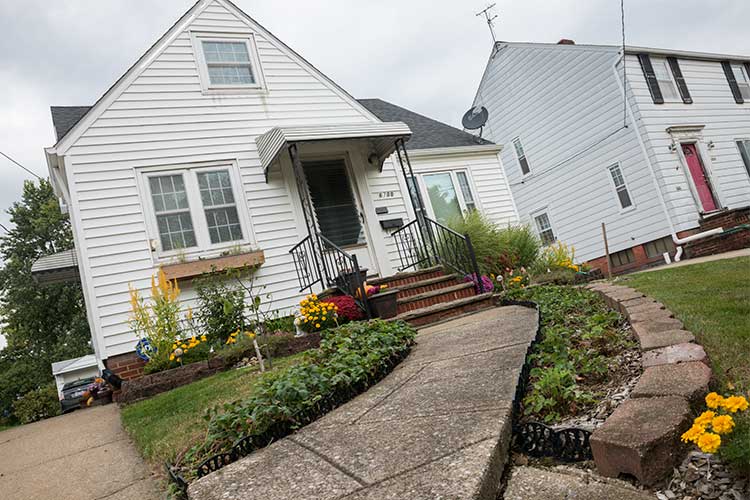 Ronald grows strawberries along the sidewalk to his home at Orchard Grove CSA