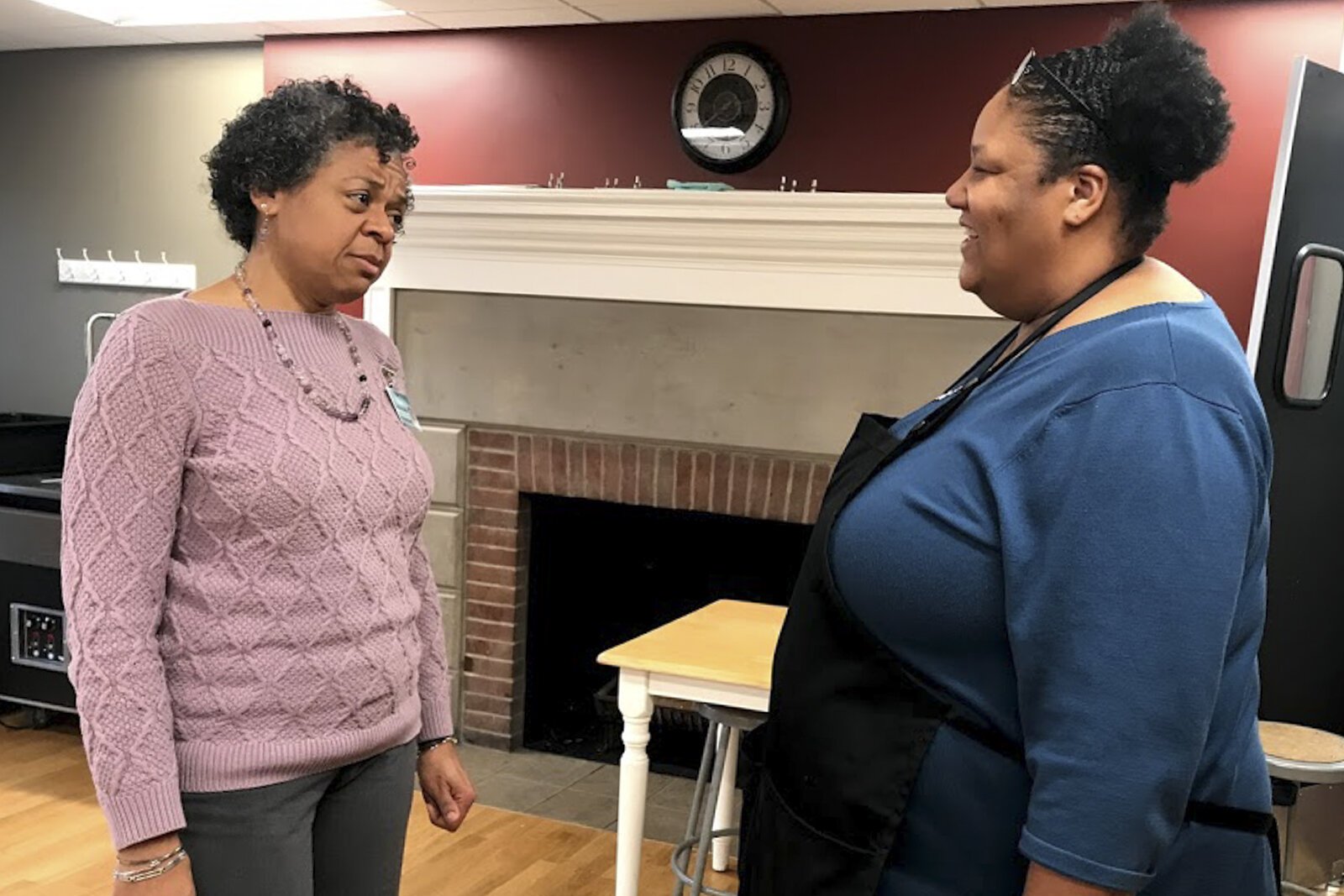 <span class="content-image-text">Jacqui Miller, principal of Stonebrook Montessori in Cleveland's Glenville neighborhood, talks with kitchen manager Pamela Harris. Miller is moving into a rehabbed home in Glenville.</span>