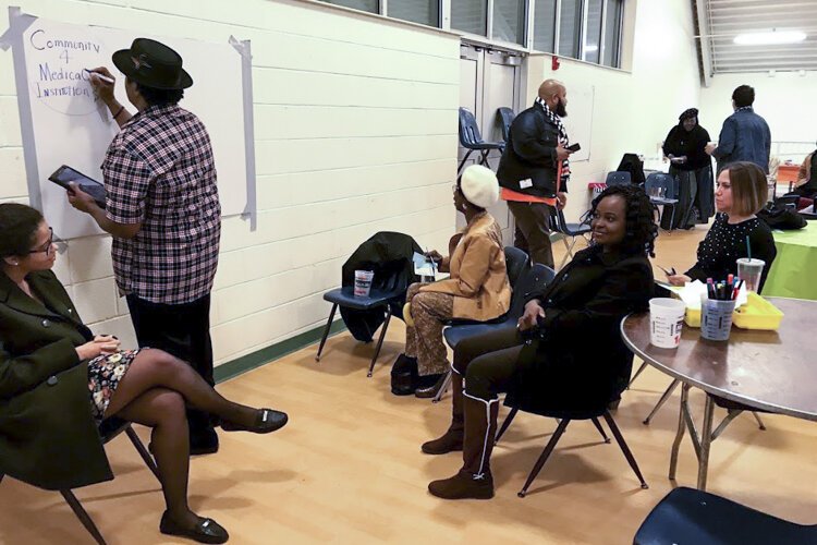 <span class="content-image-text">Doctors meet community members during a reverse ride-along of Cleveland's Central neighborhood in November.</span>