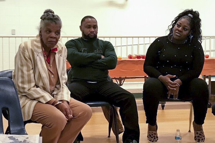 Community members listen during a reverse ride-along of Cleveland's Central neighborhood in November.