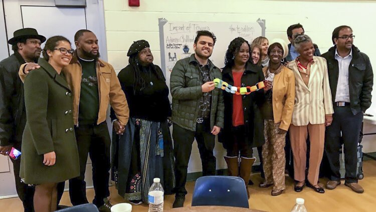 Doctors and community members pose for a group photo during a reverse ride-along of Cleveland's Central neighborhood in November.