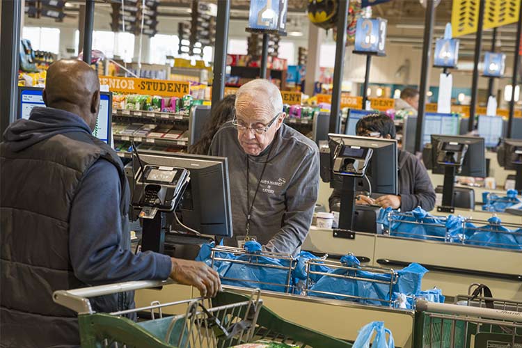 Burt Saltzman, Aaron and David's grandfather checking out customers