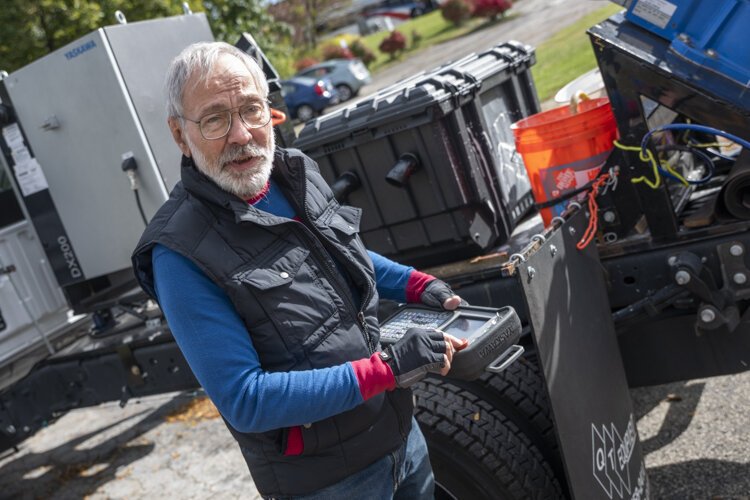 Sam Bell explains the control pad that runs the robotic arm.