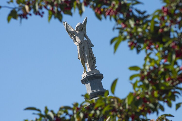 An angel gazes down from atop the Jeptha Wade monument.