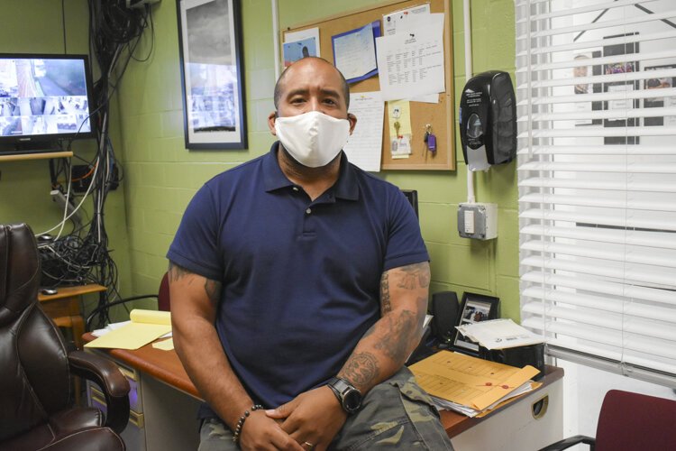 David Blunt, director of operations at Lutheran Metropolitan Ministry’s men’s shelter, sits at his desk at the homeless shelter at 2100 Lakeside Avenue in Cleveland.