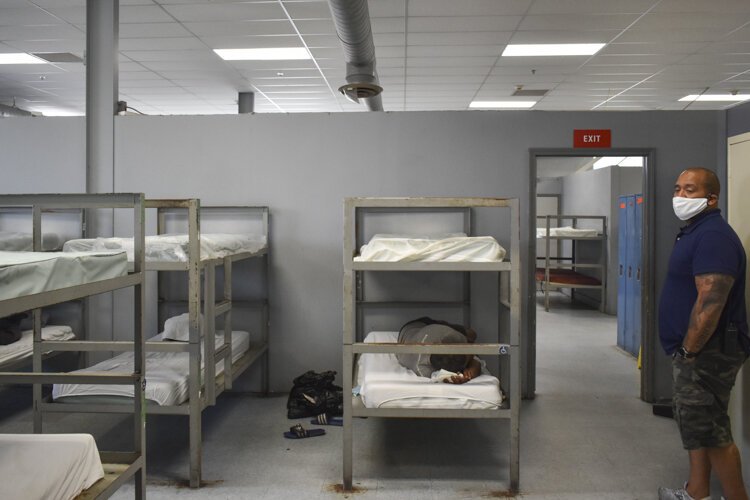 David Blunt inside the shelter’s dormitory room, where the shelter has attempted to space out beds as much as it can.