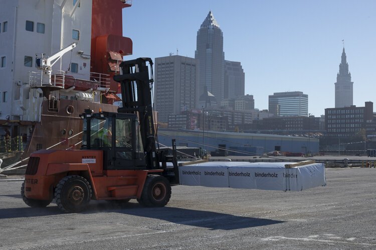 Timber headed for the construction site for INTRO being unloaded at the Port of Cleveland.