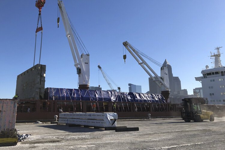 Timber headed for the construction site for INTRO being unloaded at the Port of Cleveland.