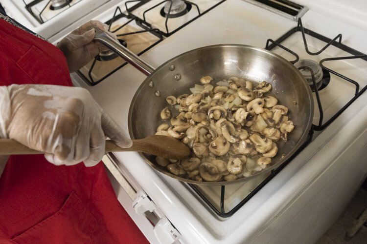 <span class="content-image-text">A Cedar High Rise senior sautees some mushrooms for a healthy quiche.</span>