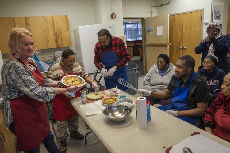 Susan Porter presents a finished delicious, healthy quiche after a Recipe Re-mix project session.
