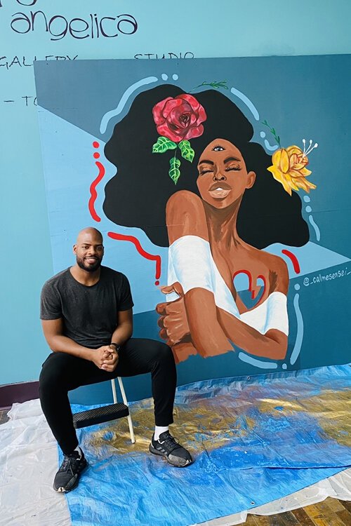 <span class="content-image-text">Artist Rashaun Dillard with his mural at the 5th Street Arcades.</span>