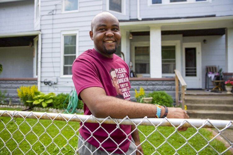 <span class="content-image-text">Mayele Degaule outside his home.</span>