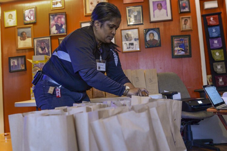 Babies and Brunch volunteers meet each morning and pack bags with breakfast, lunch, and hand sanitizer, and deliver the meals to designated households.