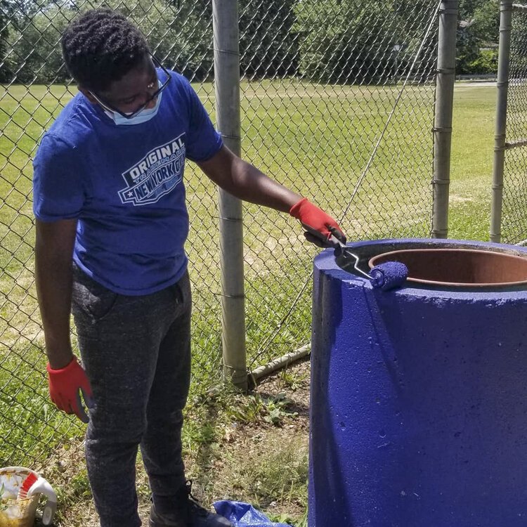 <span class="content-image-text">Teenagers in the Youth Opportunities Unlimited employment program doing beautification projects in the neighborhood.</span>