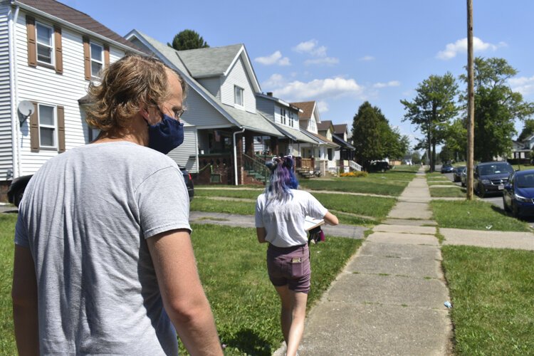 Cleveland DSA members Anna Powaski and Chad Falatic head toward the home of a local renter who faces an eviction case.