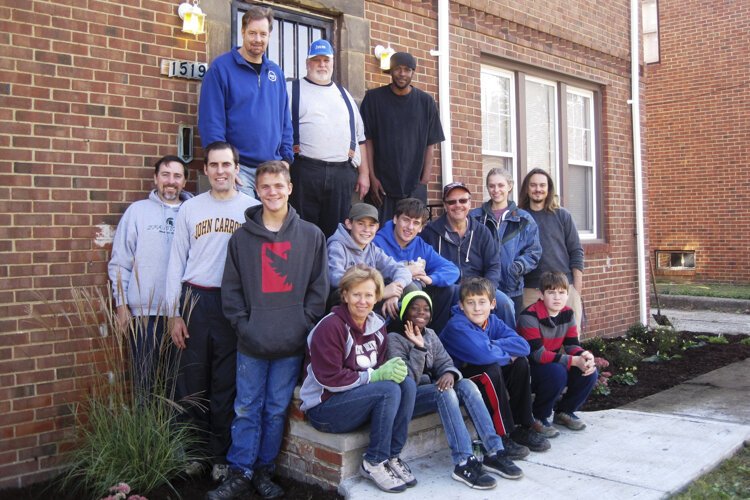 Michael Sering with staff and volunteers from Boy and Girl Scouts who volunteered to do landscaping at Luthern Metro's Shared Housing duplex, part of their affordable housing initiative.
