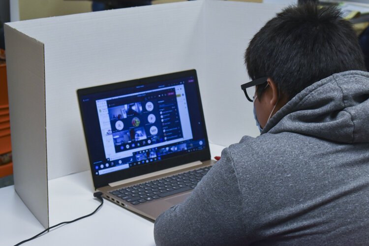 <span class="content-image-text">One of the CMSD students does his classwork at a learning pod inside Esperanza’s offices in Cleveland.</span>