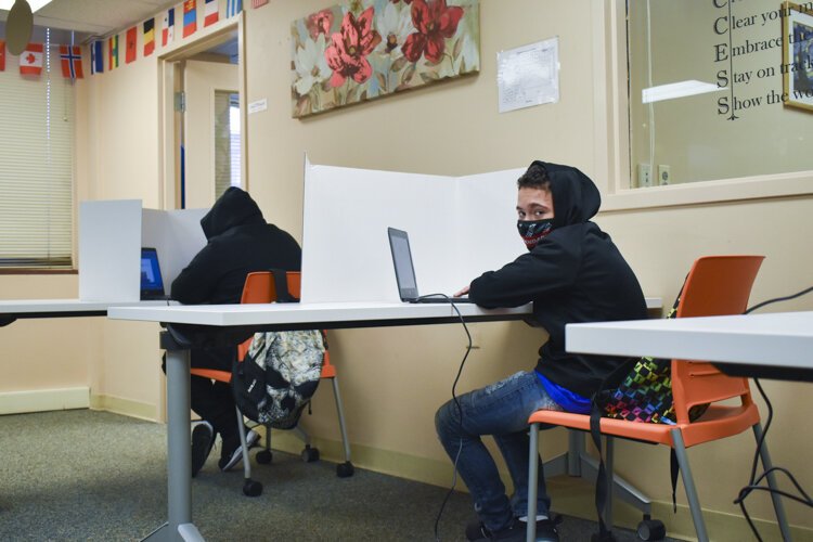 Dialeyshka Rivera, a CMSD student, sits at his computer at a learning pod inside Esperanza’s offices in Cleveland.