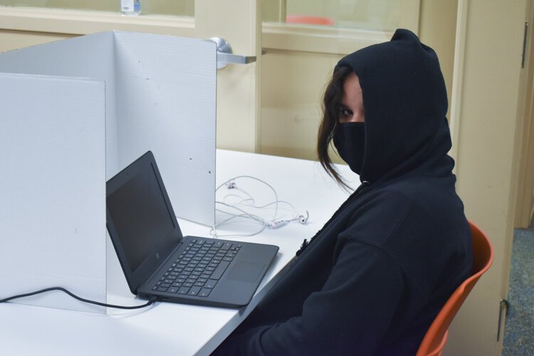 Efraniel Rivera, a CMSD student, sits at her computer at a learning pod inside Esperanza’s offices in Cleveland.