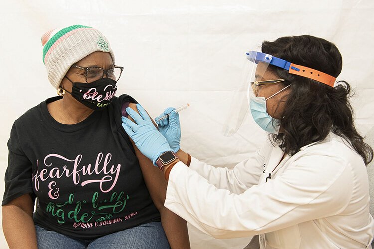 <span class="content-image-text">Irma McQueen receives a COVID-19 vaccine at the Langston Hughes Health and Education Center.</span>