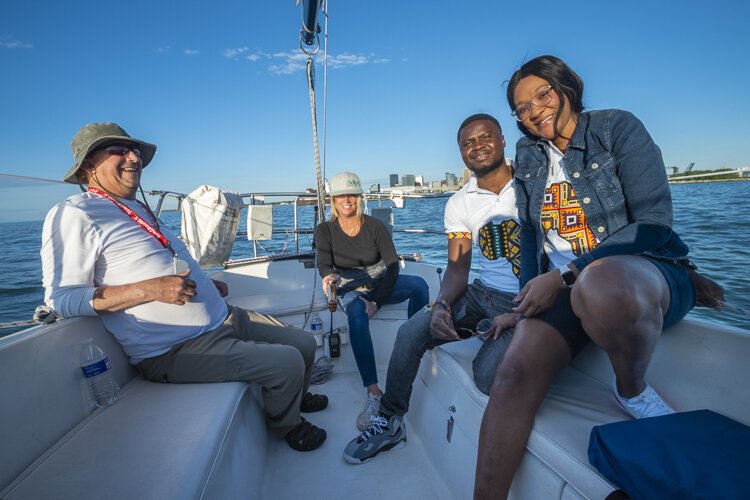 Captain Scott Sanders with first mate Cindy Bills and passengers Charlotte Atasige and Emmanuel Ketekewu of Akron originally from Ghana, West Africa.