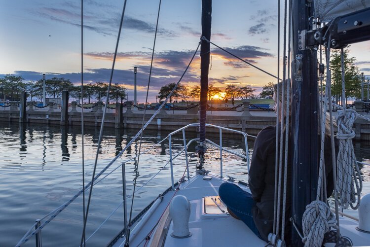 First Mate Cindy enjoys the sunset while sailing through North Coast Harbor.