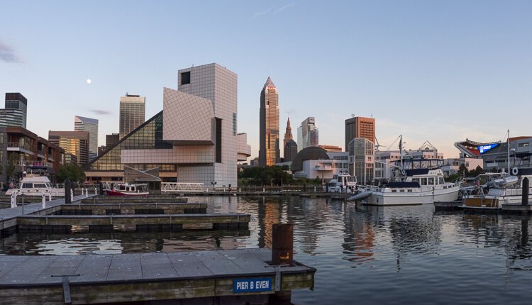 Twilight view of the city as an almost full moon begins to ascend.