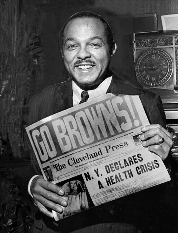 Mayor Carl B. Stokes holds a copy of the Cleveland Press for Thursday, December 26, 1968.