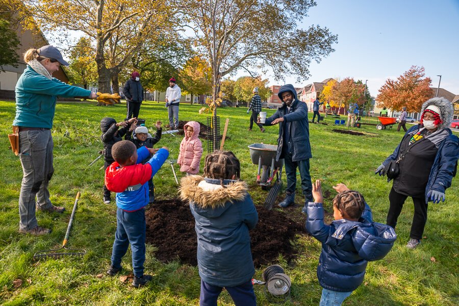 Jessica Miller, a Community Forester with Holden Forests & Gardens educating some local children during a tree planting at Carver Park Estates on Unwin Road.