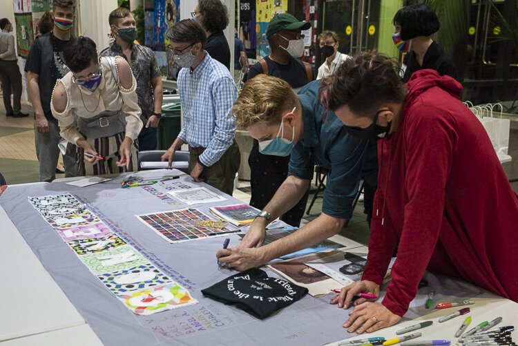 LGBTQ+ artists of CONVERGE participate in the quilt dedicated to all the LGBTQ+ artists that have died of AIDS at the MetroHealth Reception.