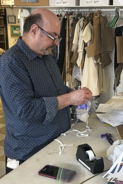 <span class="content-image-text">CPH production staff members making masks</span>