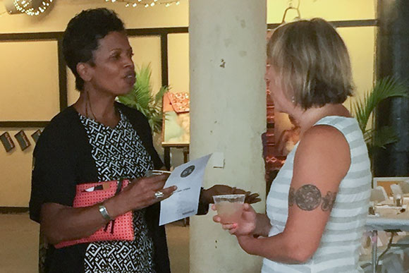 Donna Debbs, left, talking to another guest