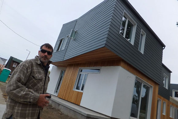 Matt Berges in front of new home still under construction on West 19th Street